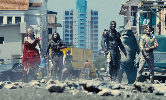 The cast of The Suicide Squad standing in rubble.